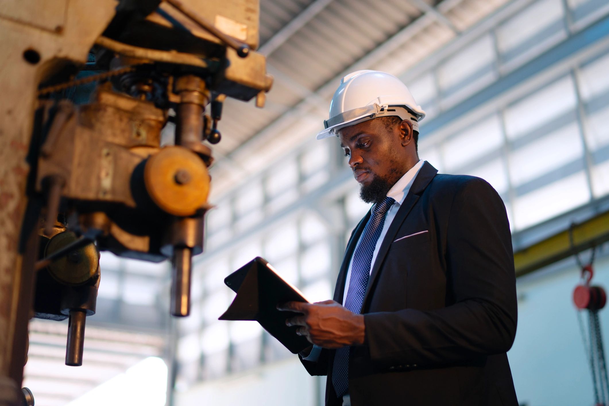 Engineer working in a metal workshop with machining equipment